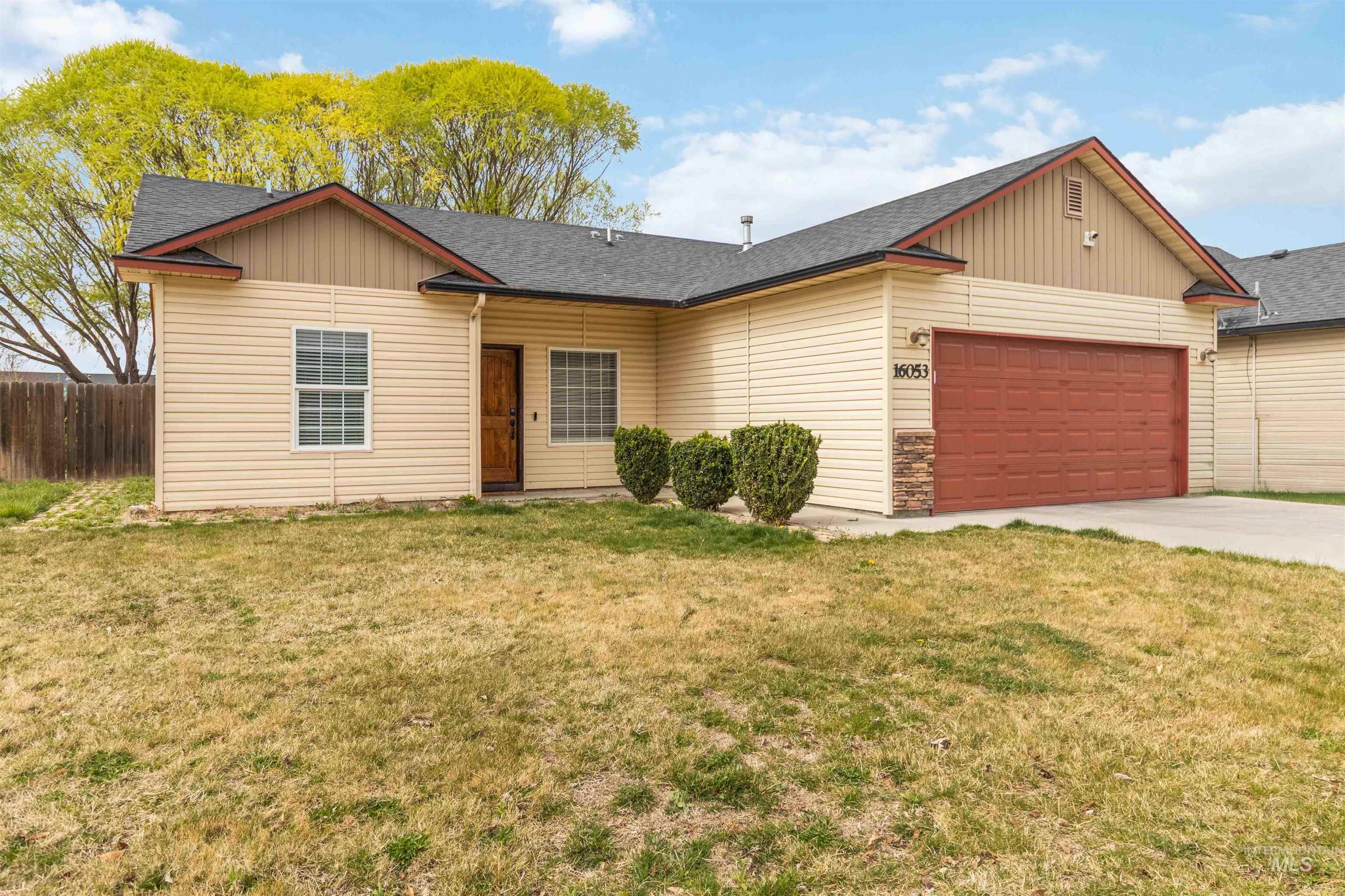 16053 Sunnyfield Avenue Caldwell, ID 83607 - Photo 2 of 35 Ranch-style home featuring roof with shingles, an attached garage, and driveway