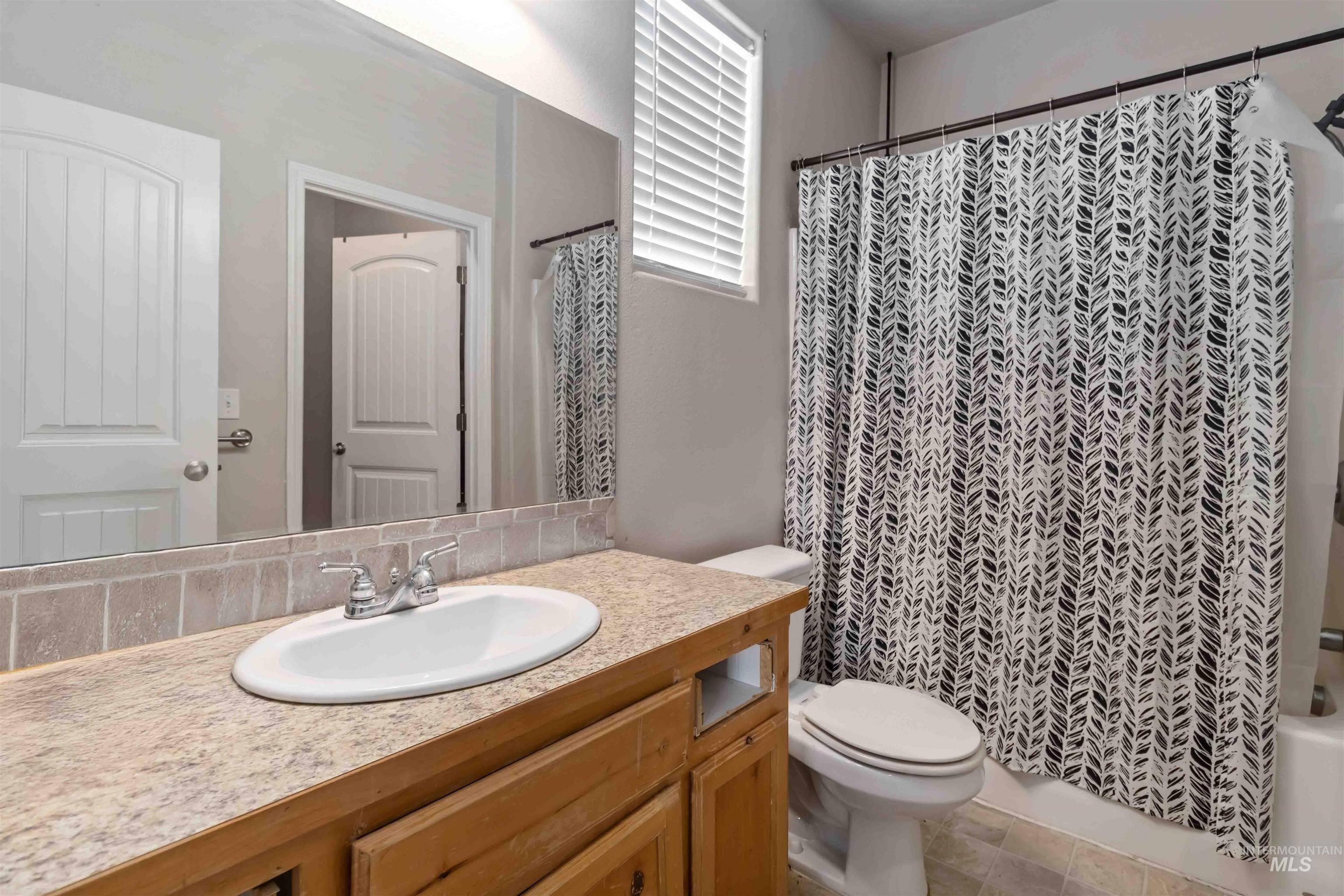 16053 Sunnyfield Avenue Caldwell, ID 83607 - Photo 20 of 35 Bathroom featuring vanity and shower / tub combo with curtain