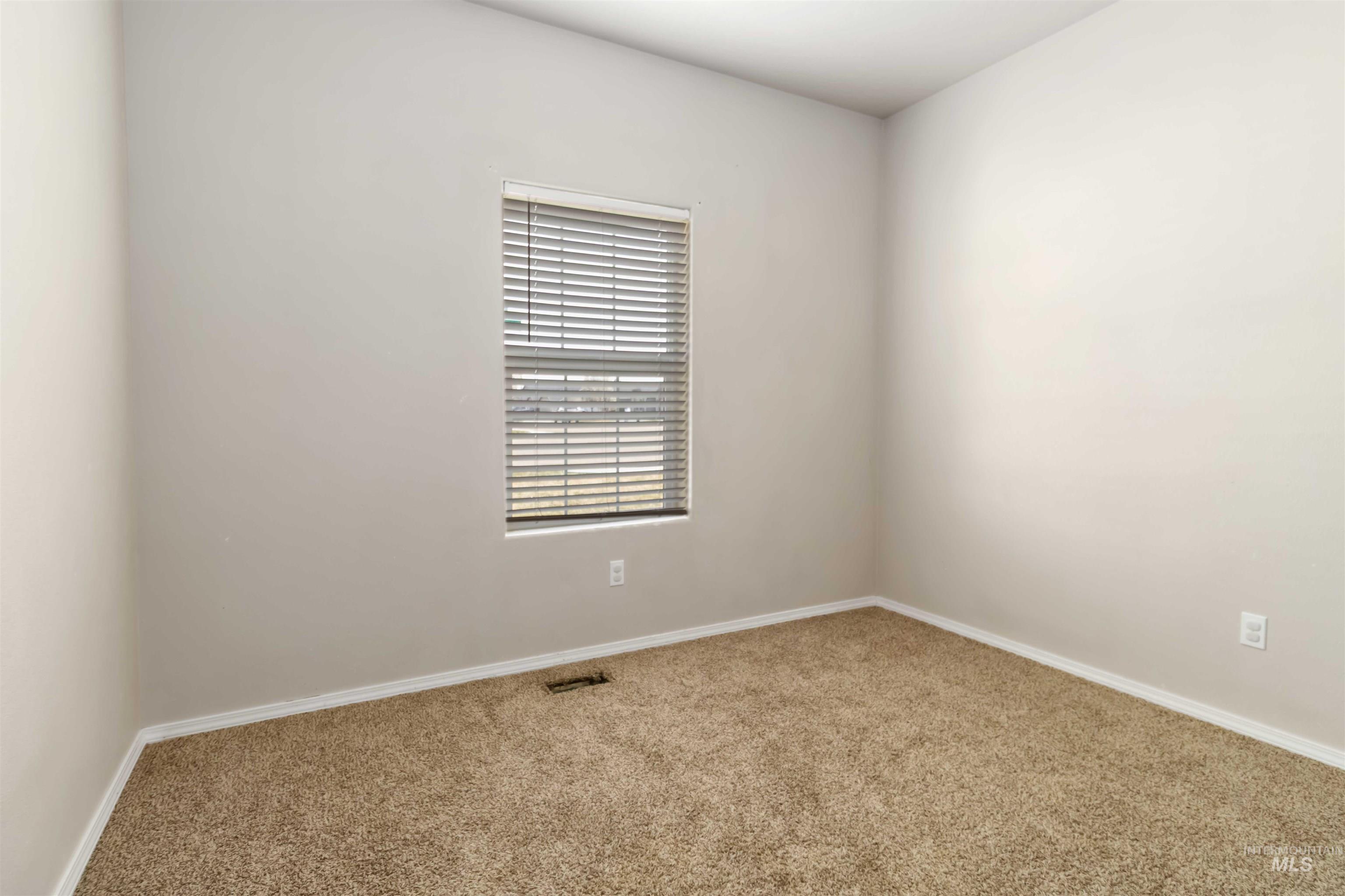 16053 Sunnyfield Avenue Caldwell, ID 83607 - Photo 26 of 35 Empty room with carpet flooring and baseboards