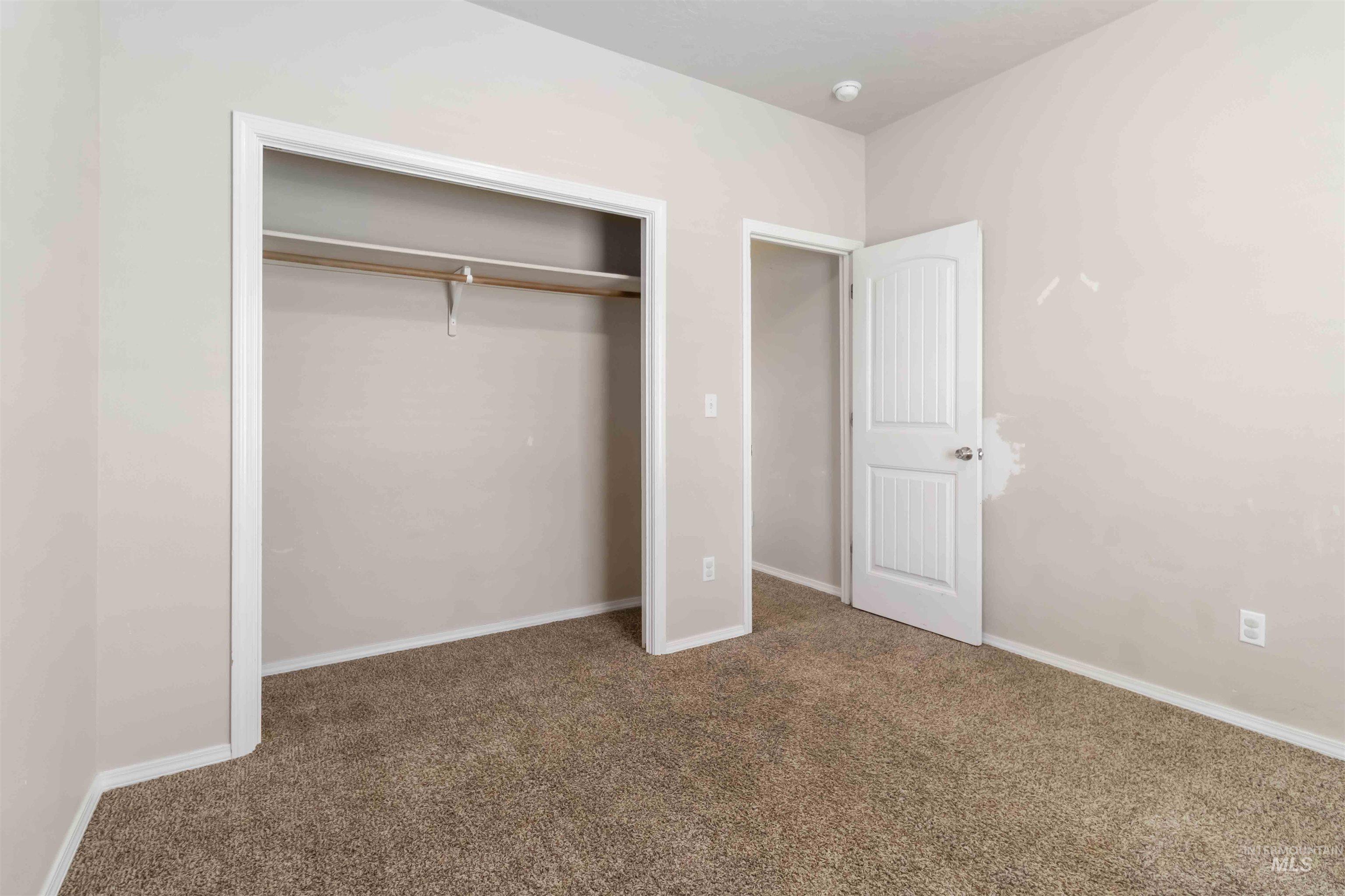 16053 Sunnyfield Avenue Caldwell, ID 83607 - Photo 27 of 35 Unfurnished bedroom featuring carpet and a closet