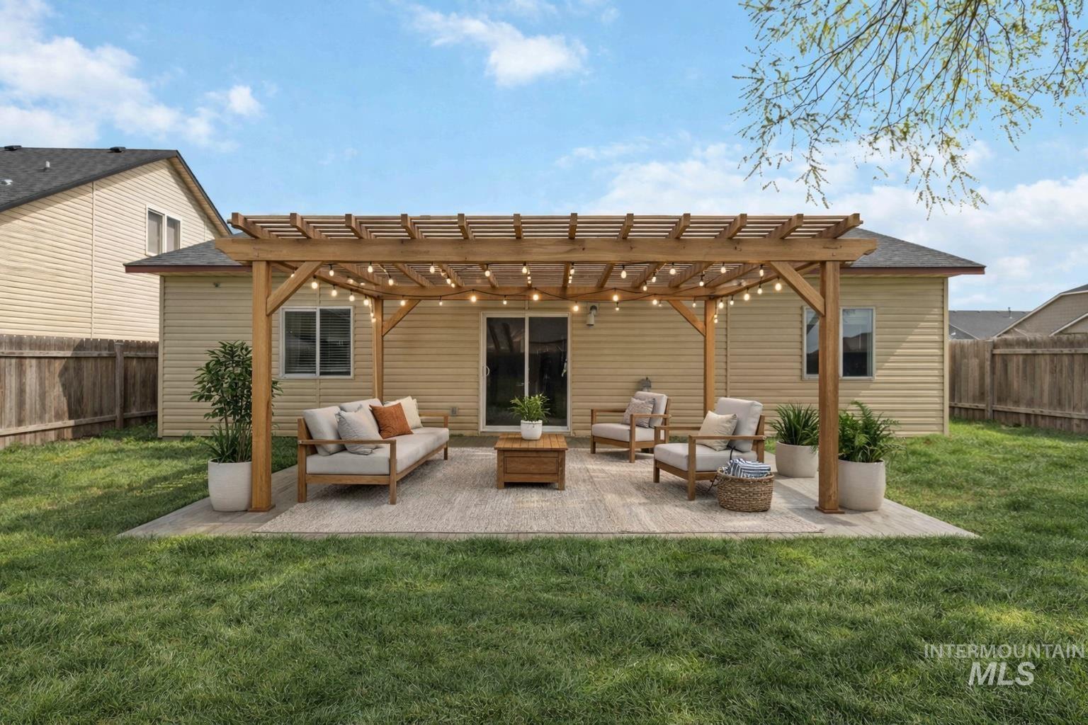 16053 Sunnyfield Avenue Caldwell, ID 83607 - Photo 34 of 35 Rear view of property with a pergola, a fenced backyard, an outdoor living space, and a patio