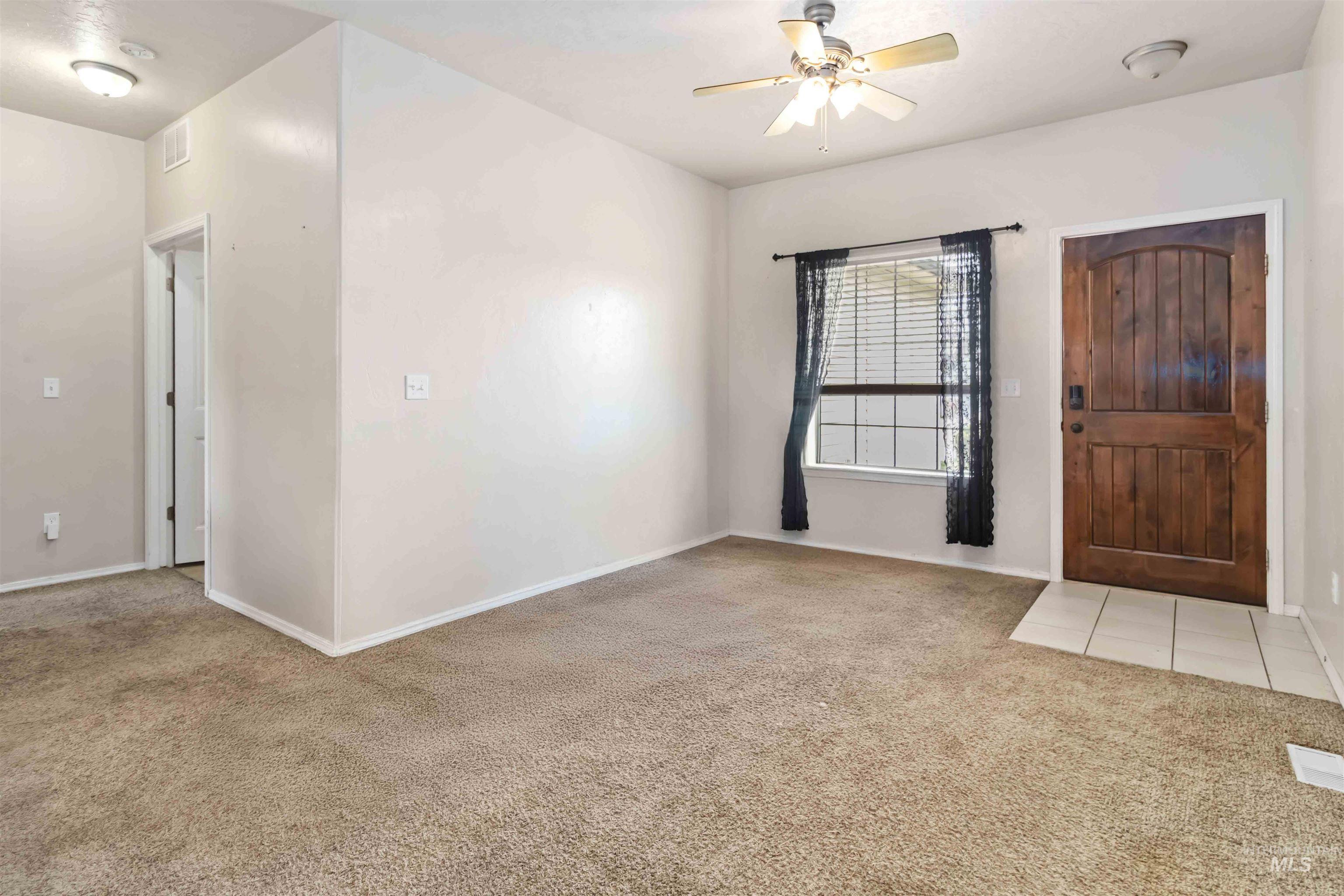 16053 Sunnyfield Avenue Caldwell, ID 83607 - Photo 4 of 35 Entryway featuring light carpet and ceiling fan