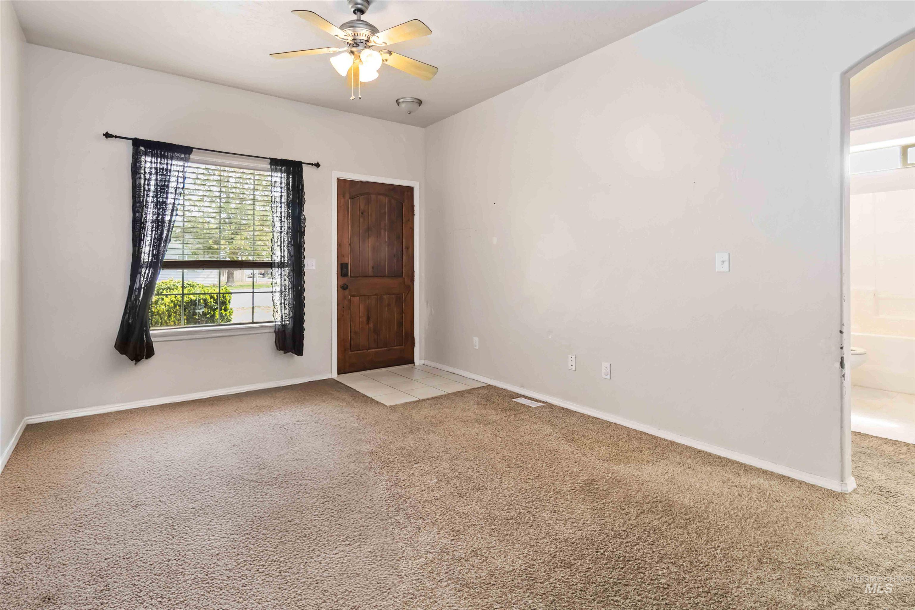 16053 Sunnyfield Avenue Caldwell, ID 83607 - Photo 5 of 35 Unfurnished room with light carpet and a ceiling fan