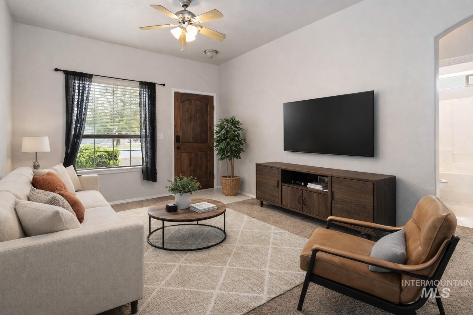 16053 Sunnyfield Avenue Caldwell, ID 83607 - Photo 7 of 35 Living area featuring ceiling fan and light carpet