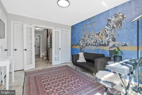 a living room with furniture and a rug