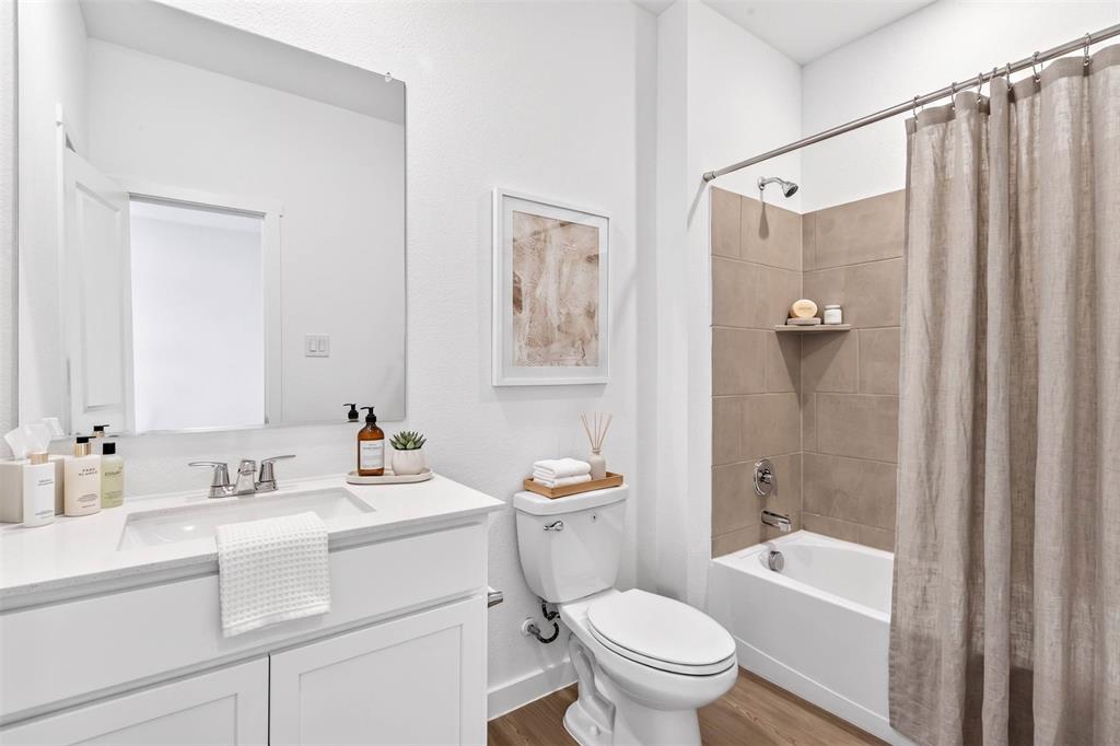 656 Waymaker Way Princeton, TX 75407 - Photo 20 of 40 Full bathroom featuring a single vanity with a white countertop and base cabinetry, a standard toilet, and a shower-over-tub combination with large format tiled walls