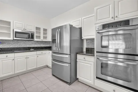a kitchen with stainless steel appliances granite countertop a sink and cabinets