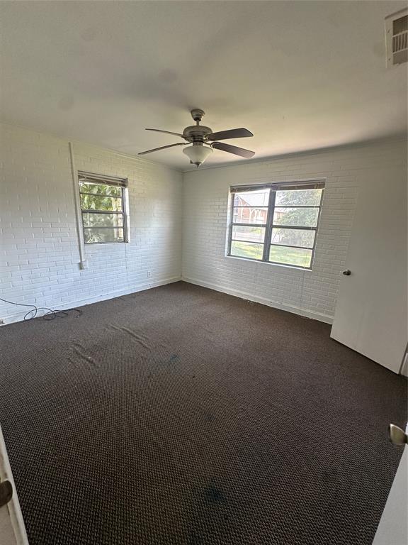 2741 Mill Street Ringgold, LA 71068 - Photo 22 of 30 an empty room with windows and ceiling fan