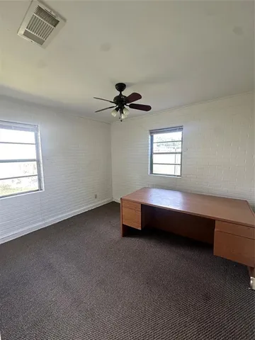 a spacious bedroom with a bed and a window