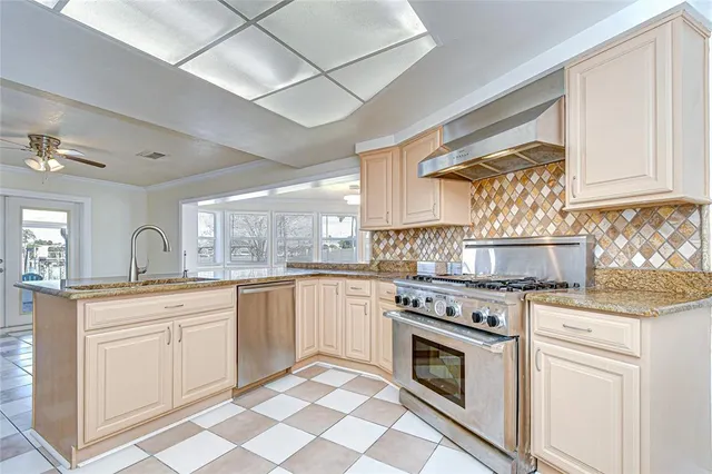 a kitchen with a stove top oven sink and cabinets