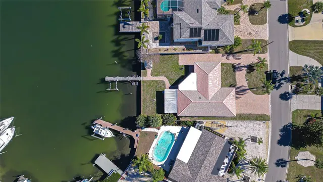 an aerial view of residential houses with outdoor space and parking