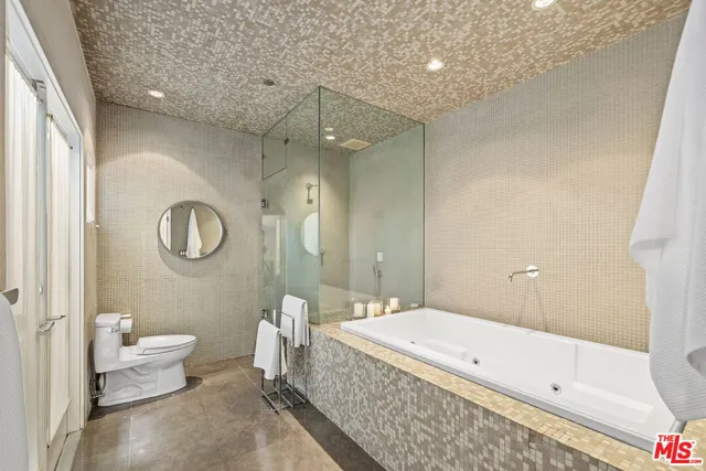 a spacious bathroom with a bathtub shower sink and toilet