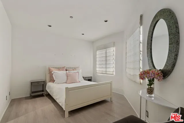 a bed sitting in a bedroom next to a window