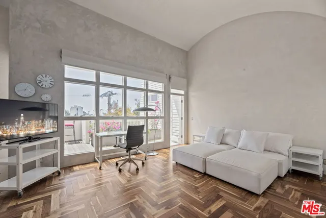 a living room with furniture and a floor to ceiling window