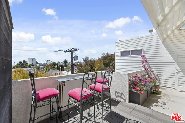 a view of a dining room with furniture and a floor to ceiling window