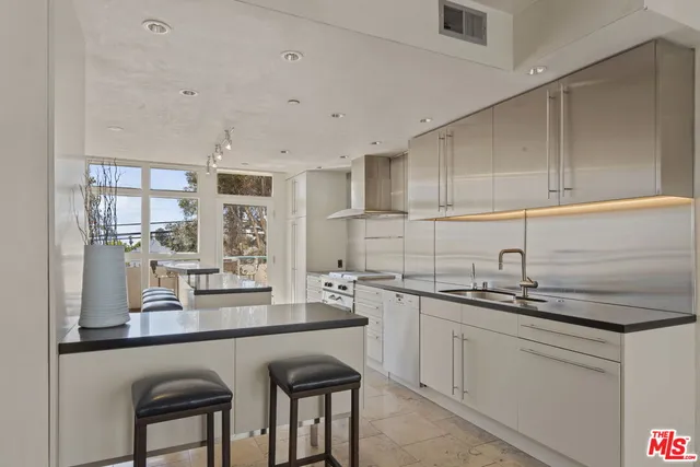 a kitchen with a sink cabinets and window