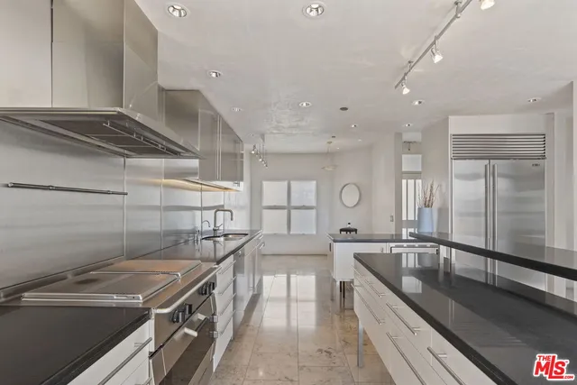 a kitchen with a stove a sink and cabinets