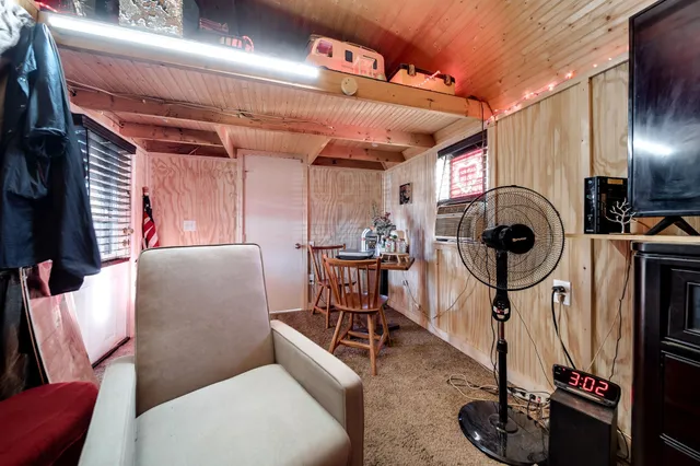 a view of a room that has a table and chairs in it