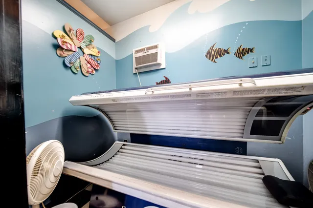 a view of a room with shelves and wooden floor