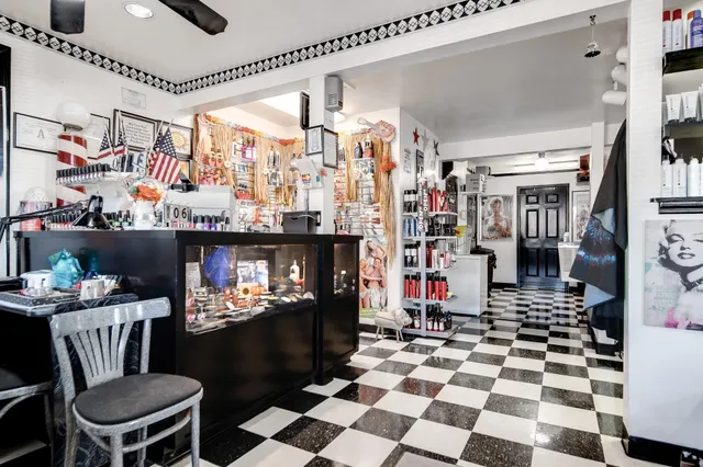 a walk in closet with wooden floor