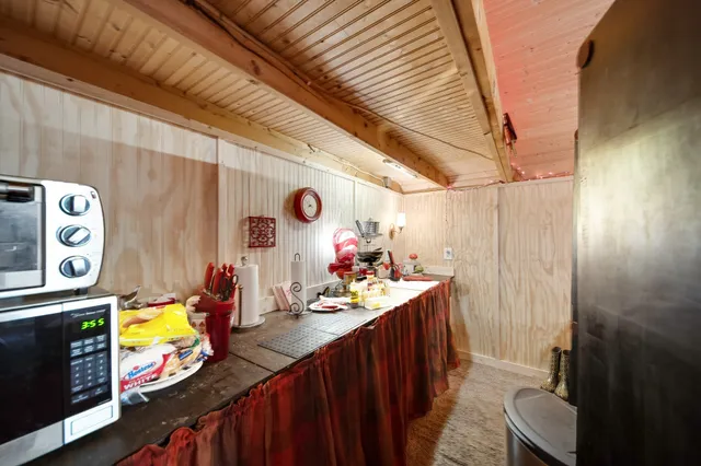 a ceiling fan sitting in a living room with furniture and a flat screen tv