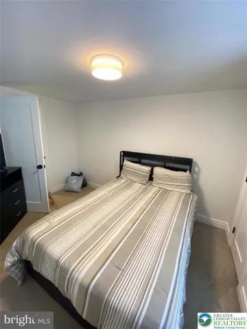 a bedroom with a bed and a night stand