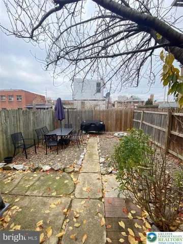 a backyard of a house with table and chairs