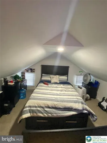 a bedroom with a bed and a night stand