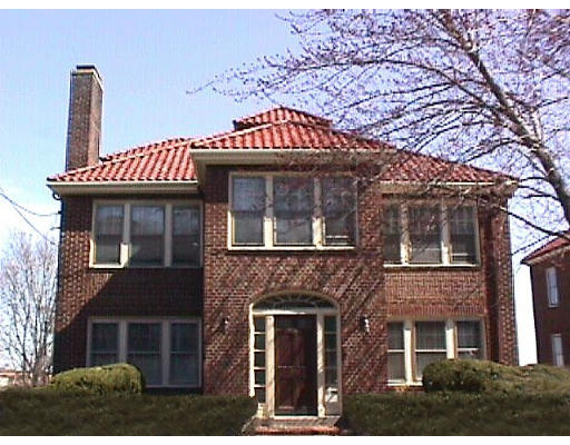 a front view of a building with a garden