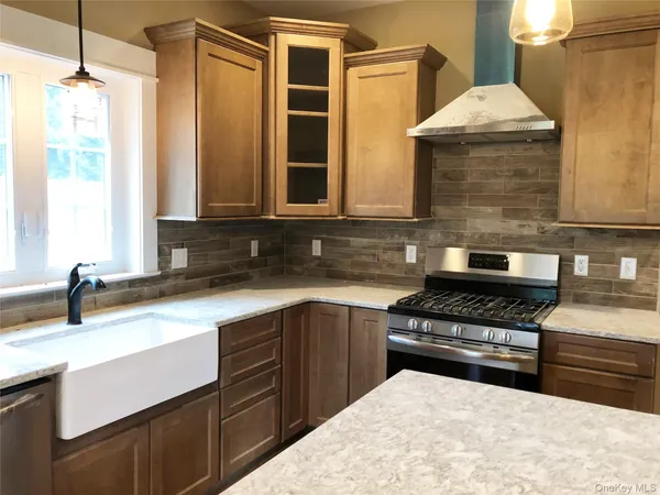 a kitchen with a sink stove and cabinets