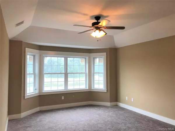 a view of room window and ceiling fan