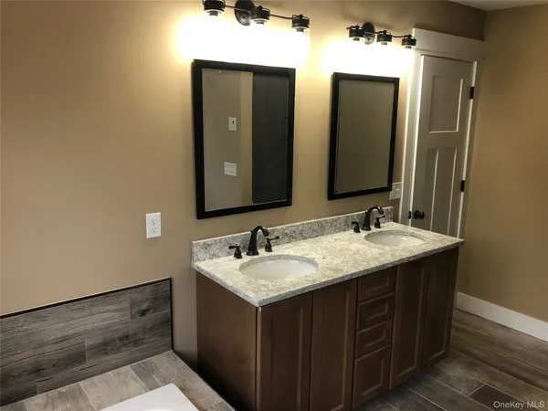 a bathroom with a double vanity sink and a mirror
