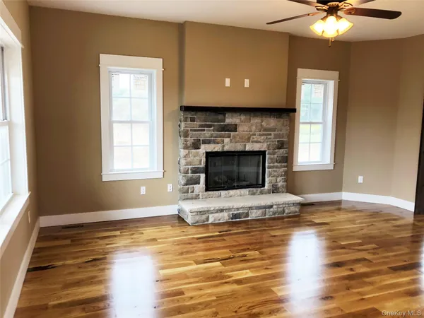 a living room with fireplace and flat screen tv