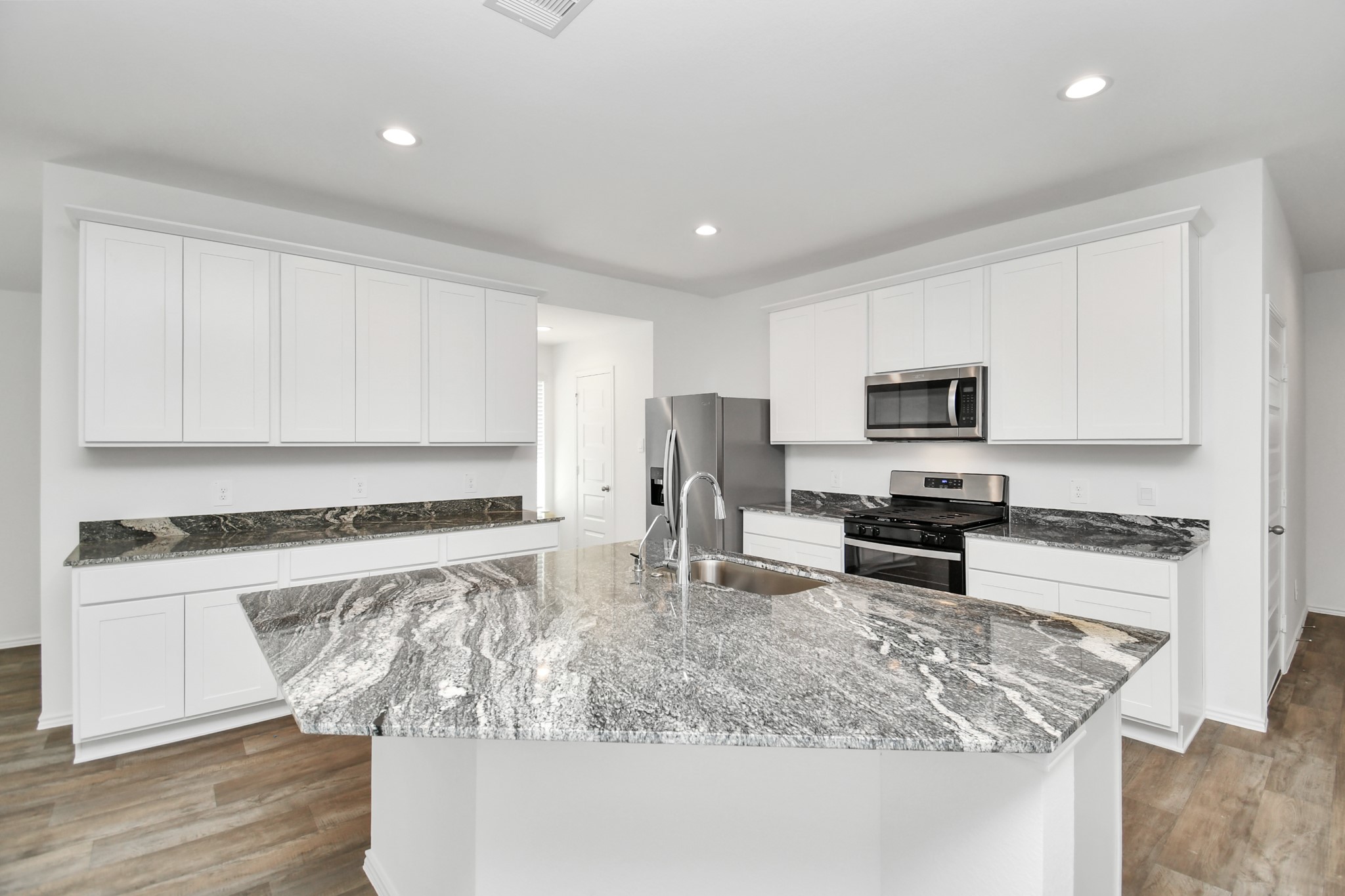 2715 Willow Gulch Way Rosenberg, TX 77469 - Photo 1 of 39 a kitchen with stainless steel appliances granite countertop a sink stove and microwave