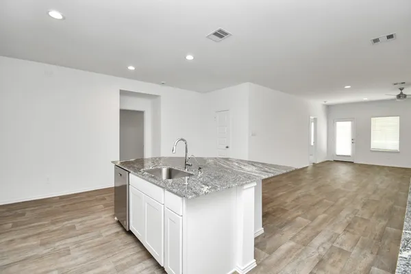 a kitchen with sink cabinets and wooden floor
