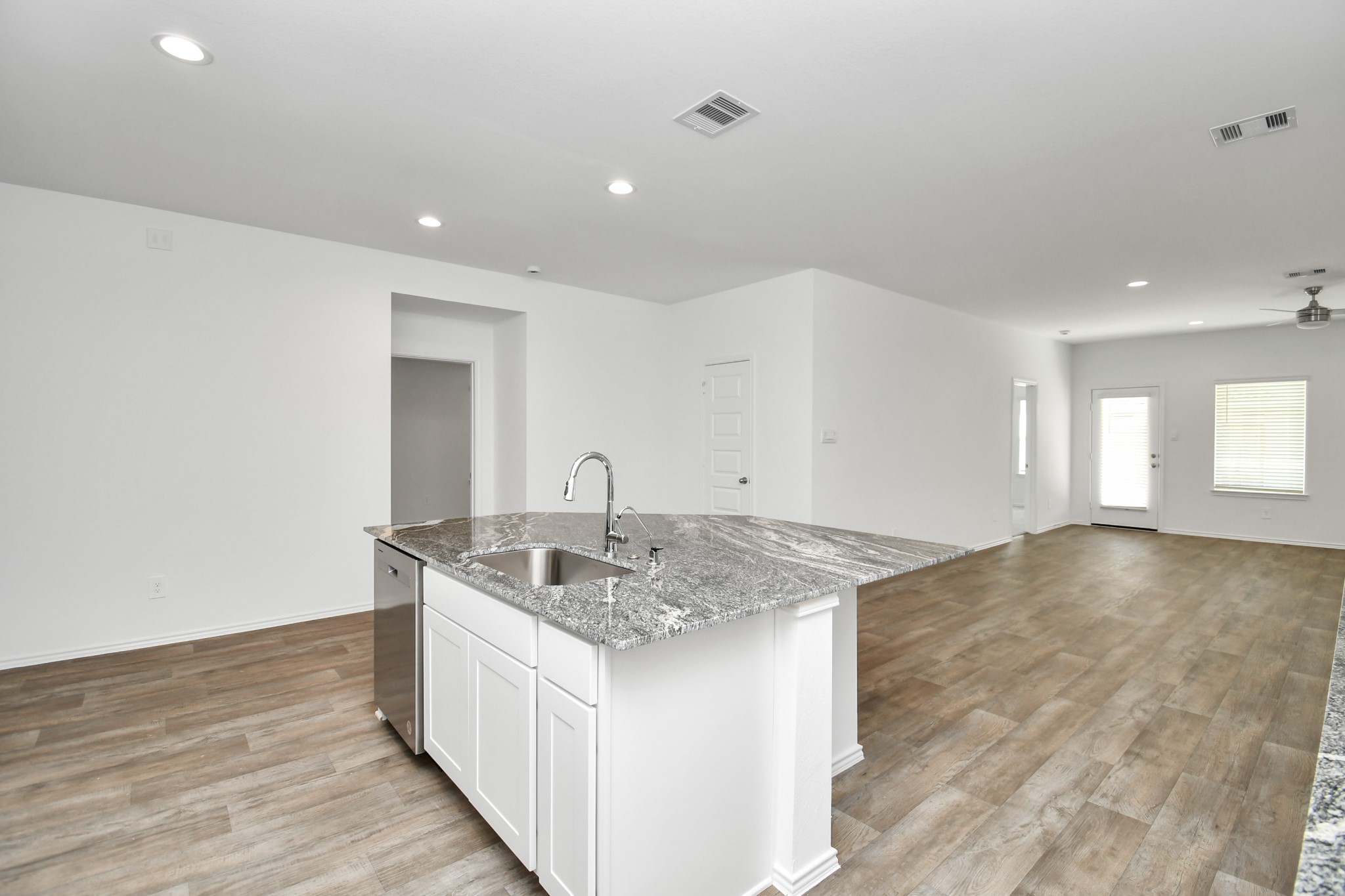 2715 Willow Gulch Way Rosenberg, TX 77469 - Photo 16 of 39 a kitchen with sink cabinets and wooden floor