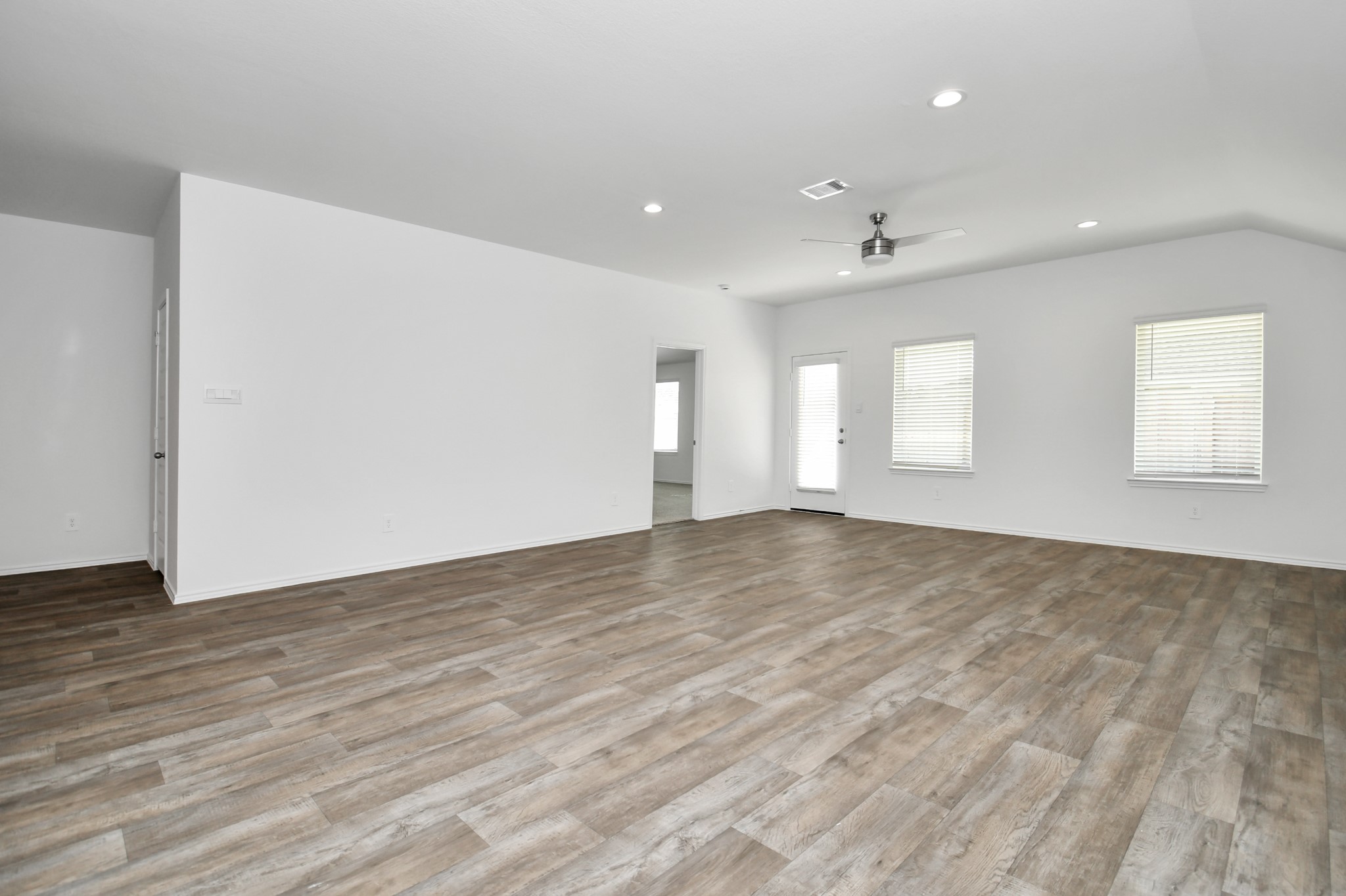 2715 Willow Gulch Way Rosenberg, TX 77469 - Photo 22 of 39 an empty room with wooden floor and windows
