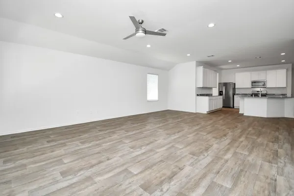 a view of a kitchen with a sink and a refrigerator