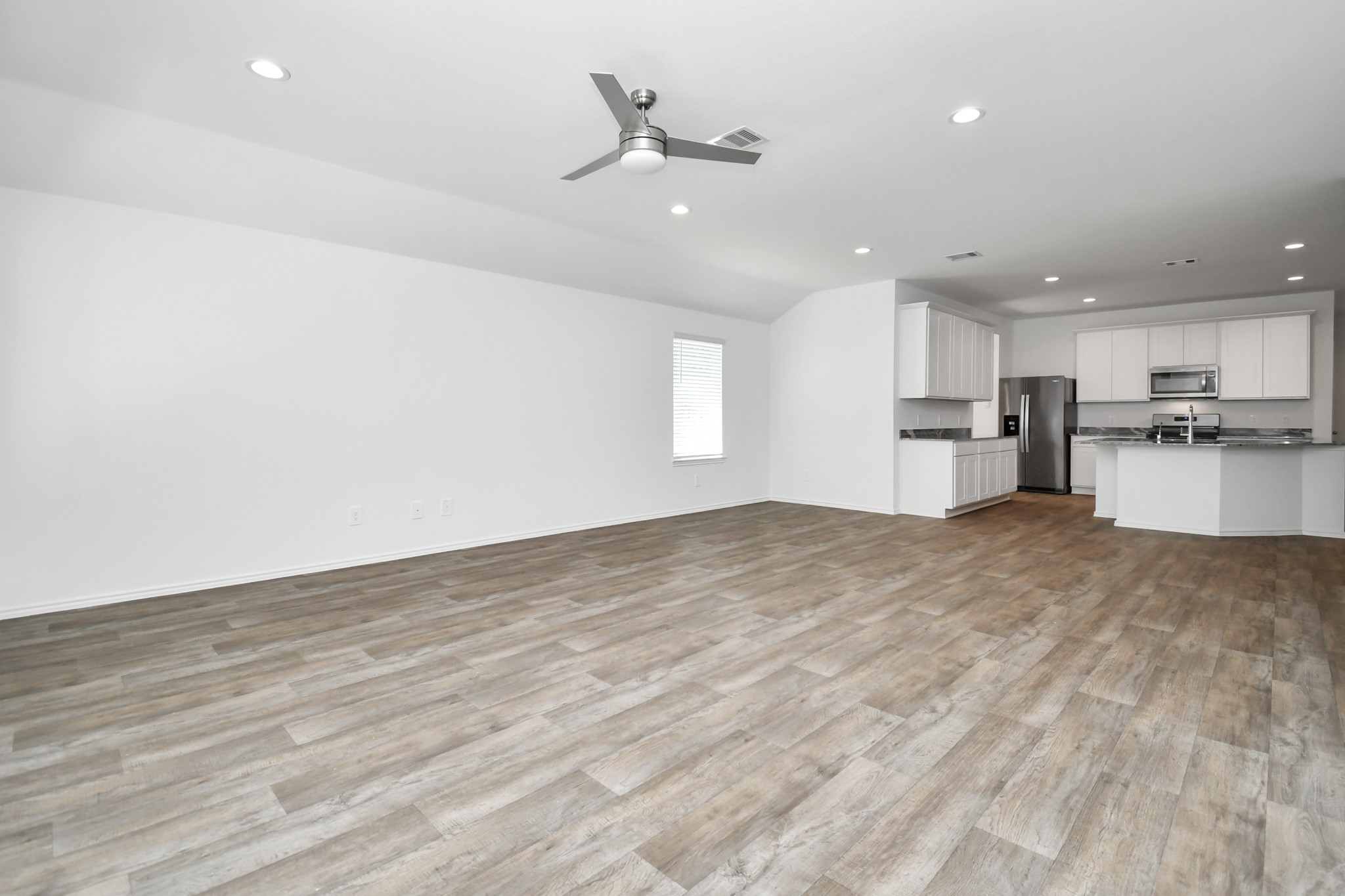 2715 Willow Gulch Way Rosenberg, TX 77469 - Photo 24 of 39 a view of a kitchen with a sink and a refrigerator