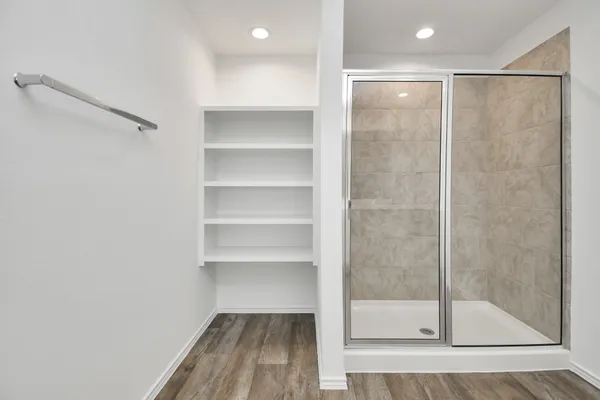 a bathroom with a glass shower door