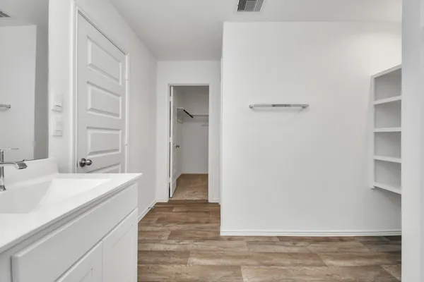 a spacious bathroom with a sink and a mirror