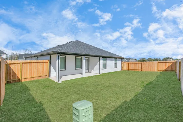 a backyard of a house with table and chairs