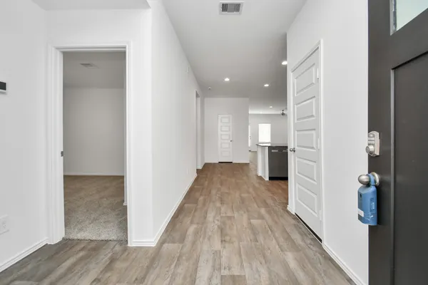 a view of a big room with wooden floor and a bathroom