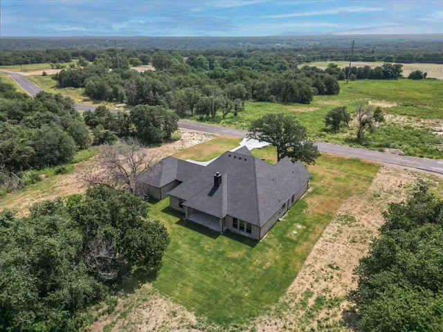 a view of a hallway with wooden floor and closet
