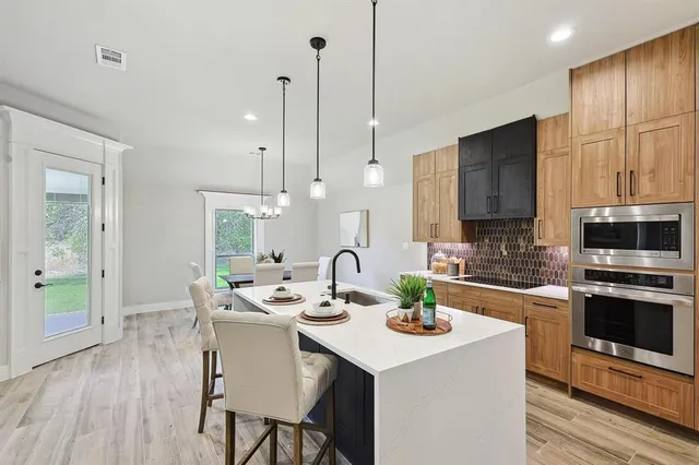 a kitchen with a sink a counter space and appliances