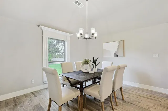 a very nice looking dining room with a table and chairs