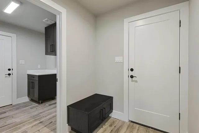 a view of walk in closet with wooden floor