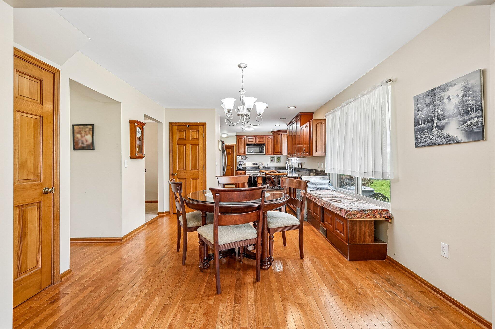 Wood-finish flooring throughout, with a built-in window bench featuring storage