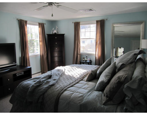 40 Pond Street Needham, MA 02492 - Photo 13 of 17 a bedroom with a bed and a flat tv screen