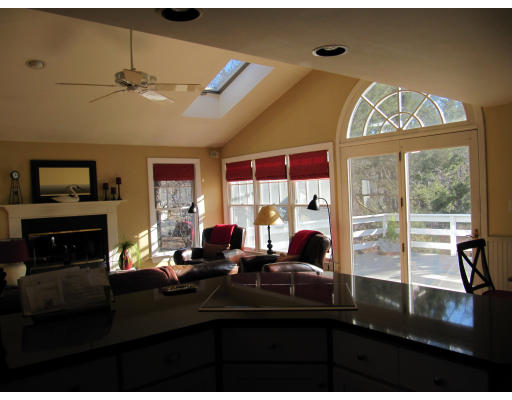 40 Pond Street Needham, MA 02492 - Photo 3 of 17 a room with furniture a flat screen tv and a floor to ceiling window